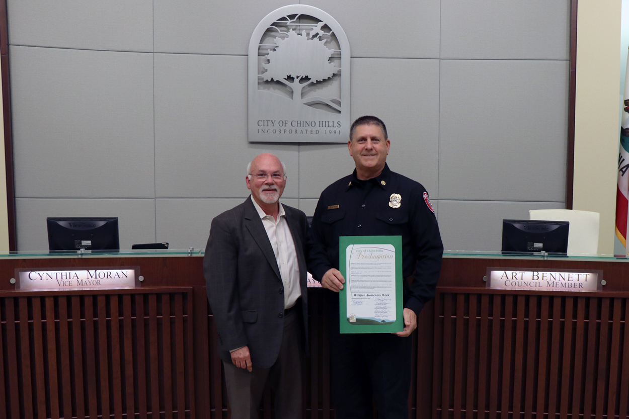 Deputy Chief Faherty accepting proclamation from Mayor Rogers